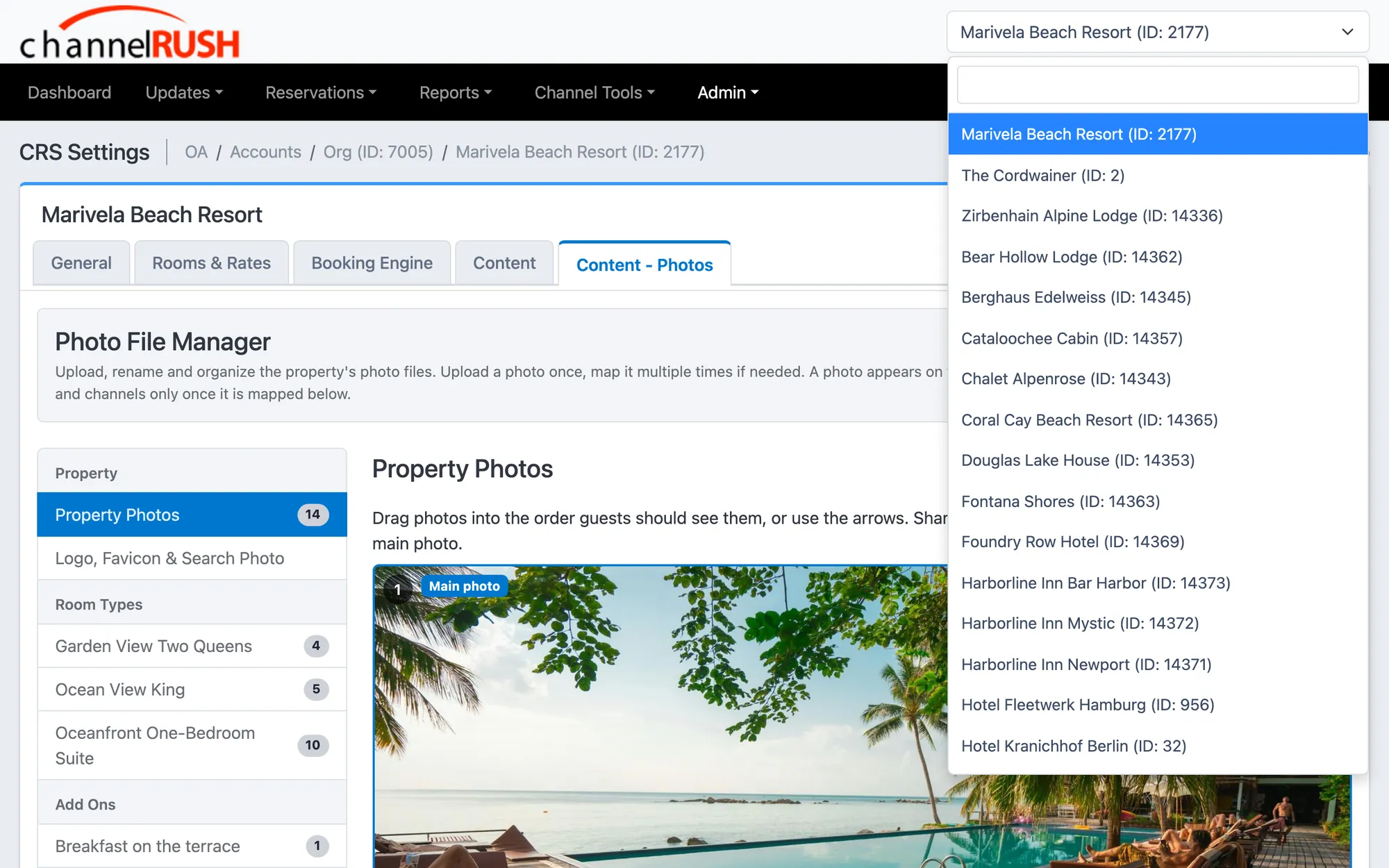 The property switcher open over the photo manager, listing the demo account's hotels and rentals